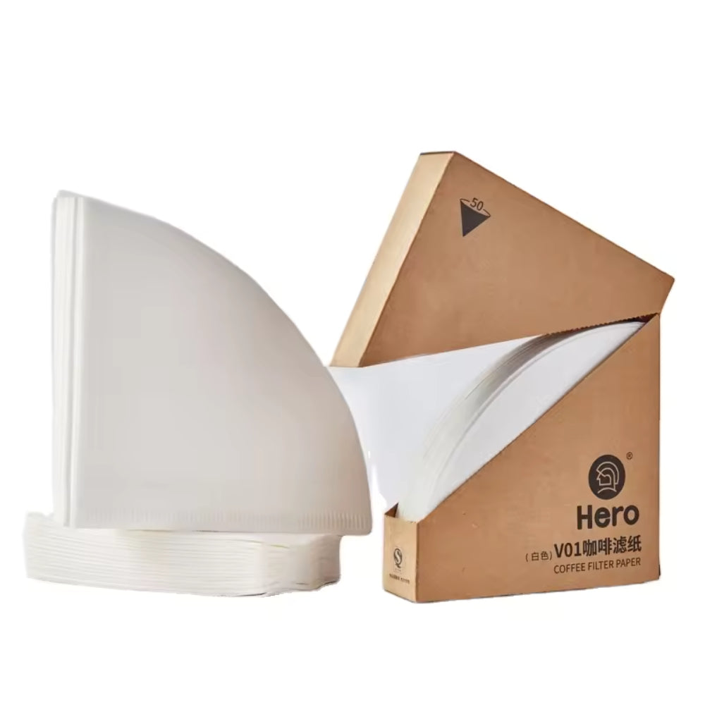 White LAMOSE zeroHero V01 cone coffee paper filters shown stacked and in their open brown cardboard box, ready for brewing.
