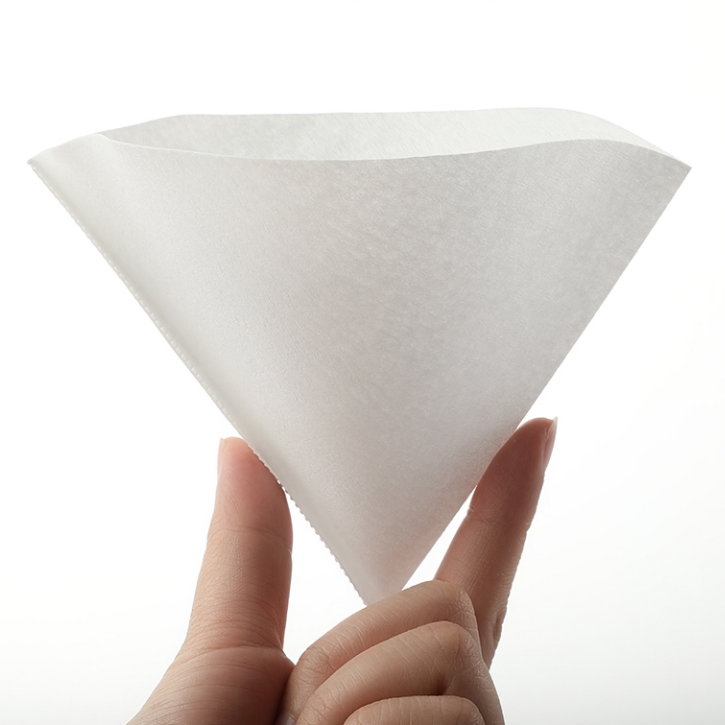LAMOSE zeroHero V01 white paper coffee filter held by fingers, showing its conical shape, texture, and crimped seam.